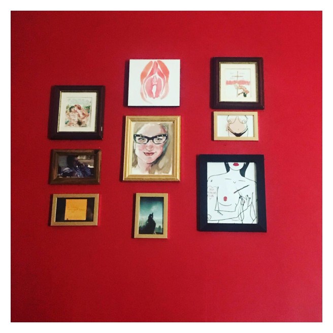 Framed art on red wall