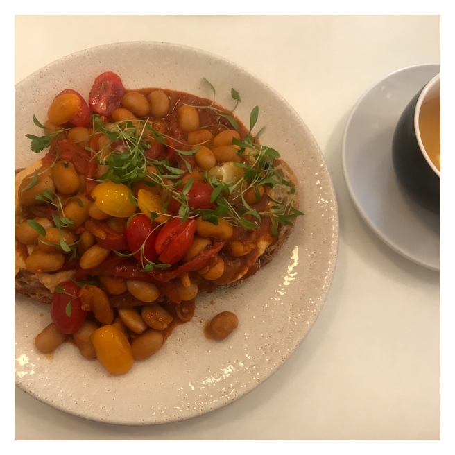 Butter beans in toast and cup of mint tea
