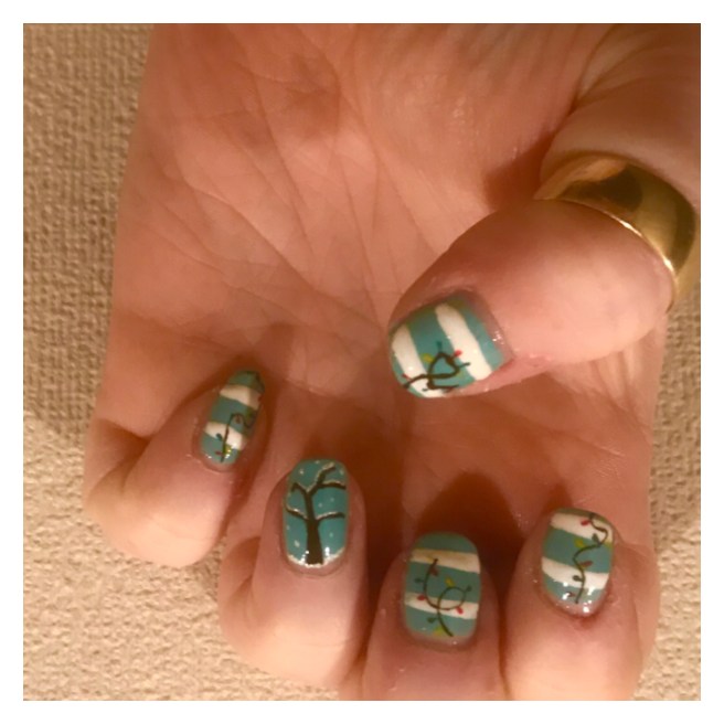 Xmas nail art. String lights on blue & white background 