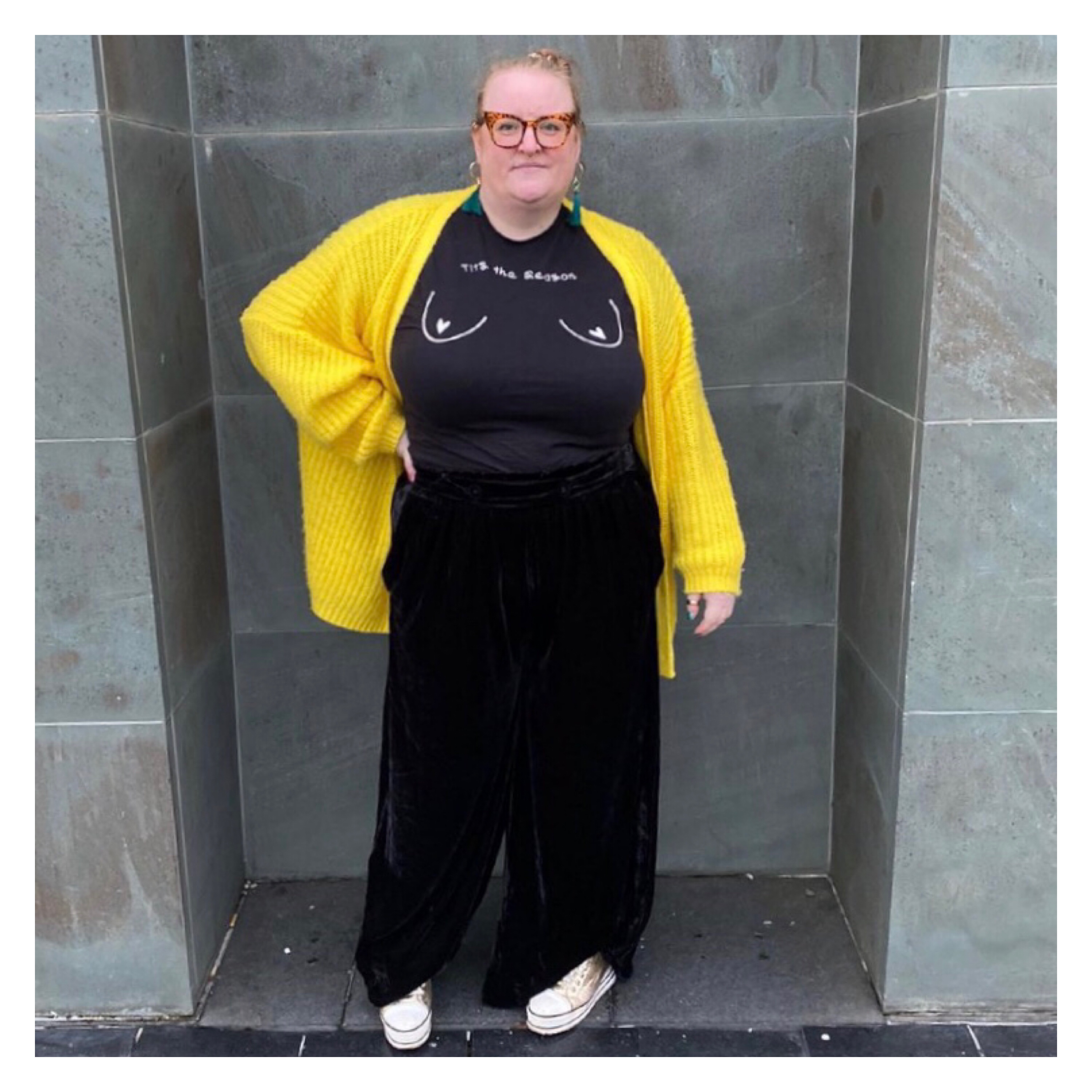 Plus size woman in black velvet trs, black t shirt & yellow cardi