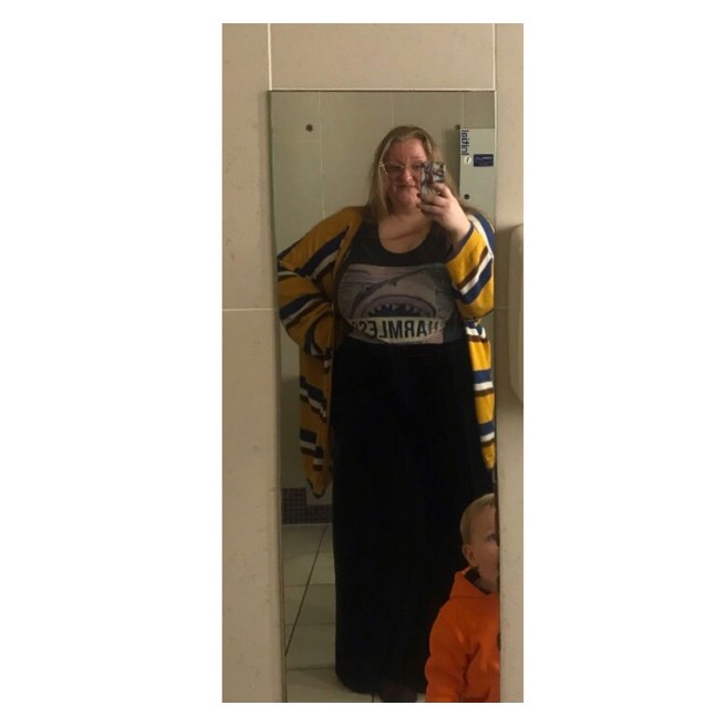 Plus size woman in shark vest & velvet trs