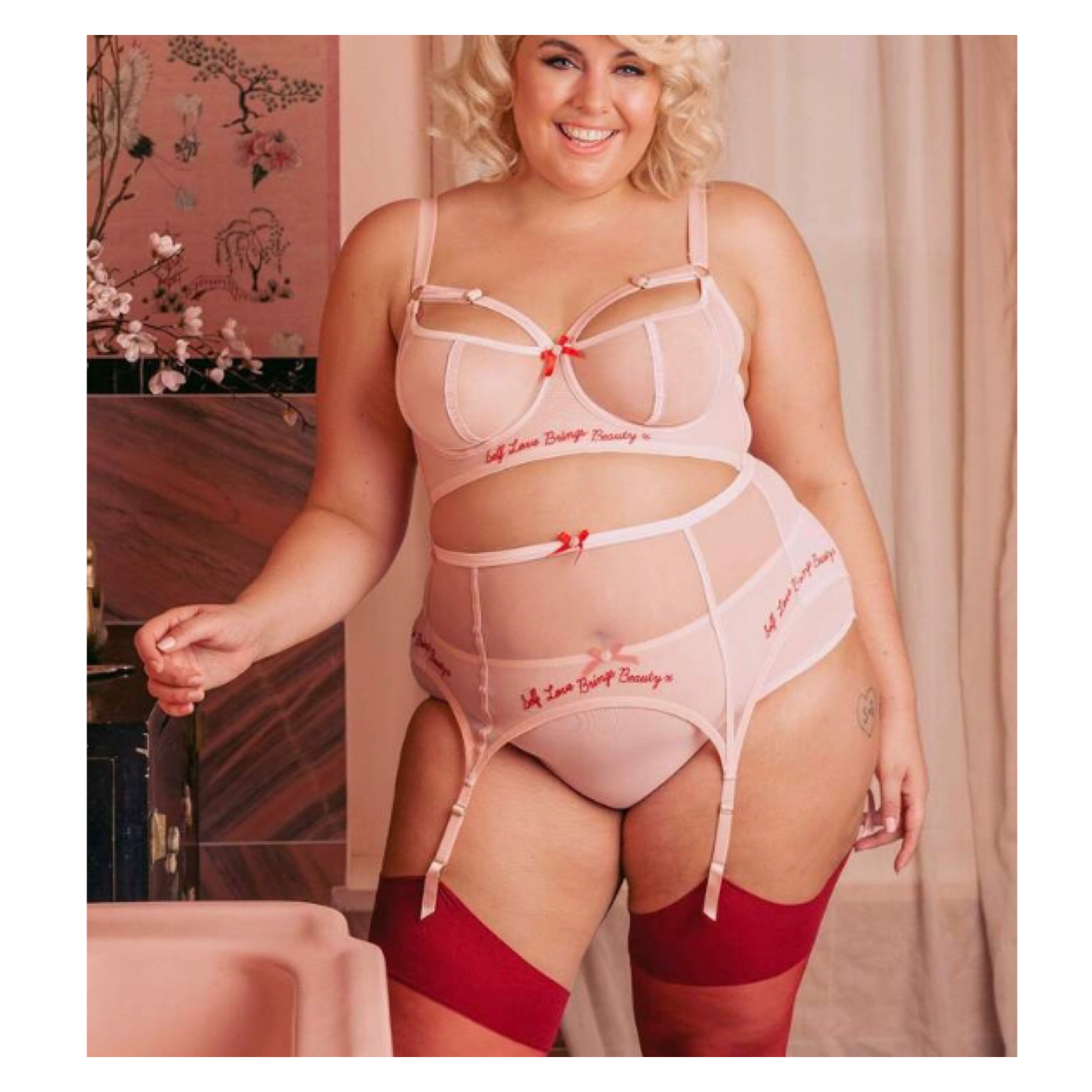 Plus size model wearing lingerie with self brings beauty embroidered on