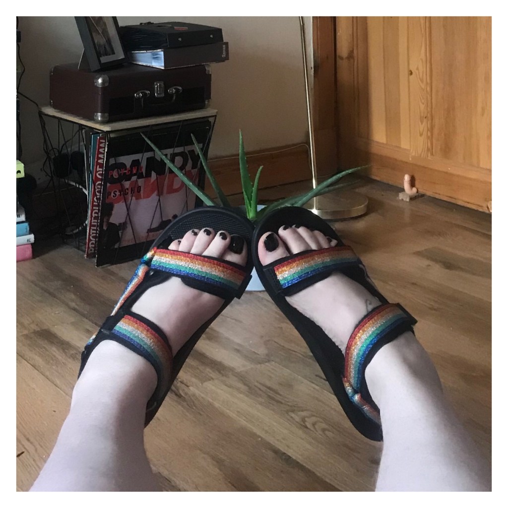 Rainbow sandals on pale feet  