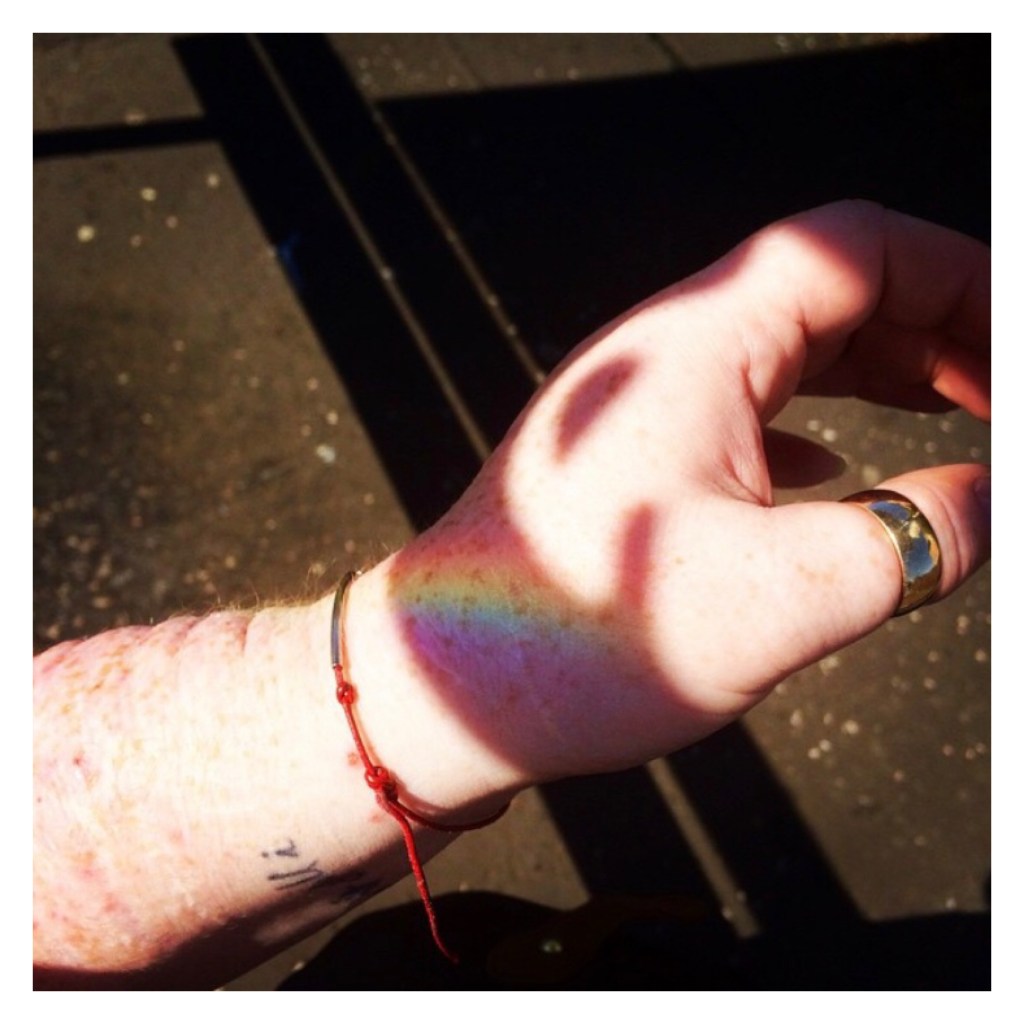Rainbow reflection on pale either arm 