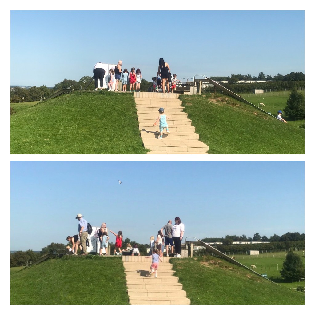 Toddlers running up steps to a slide 