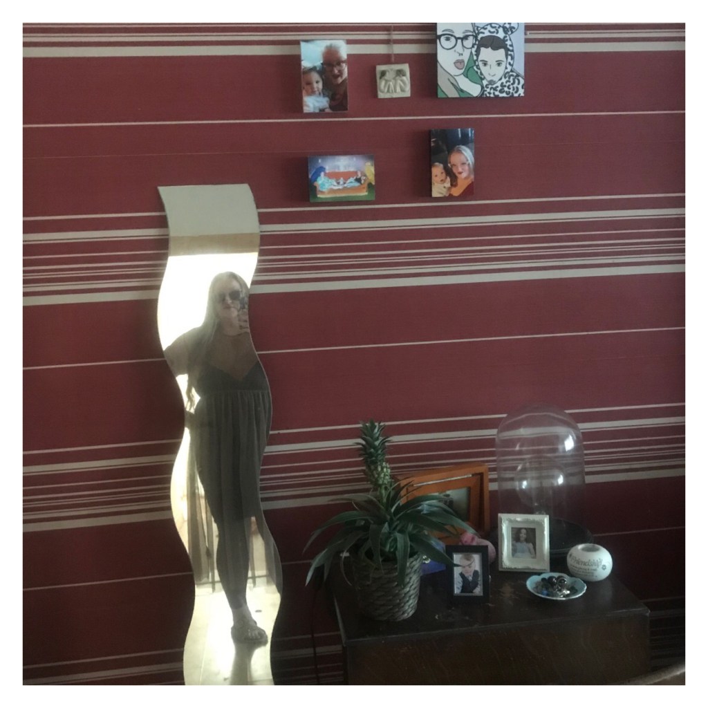 Mirror selfie of ly in sheer dress & sunglasses. 