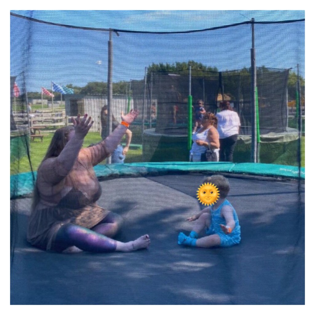 Plus size woman and toddler on a trampoline 