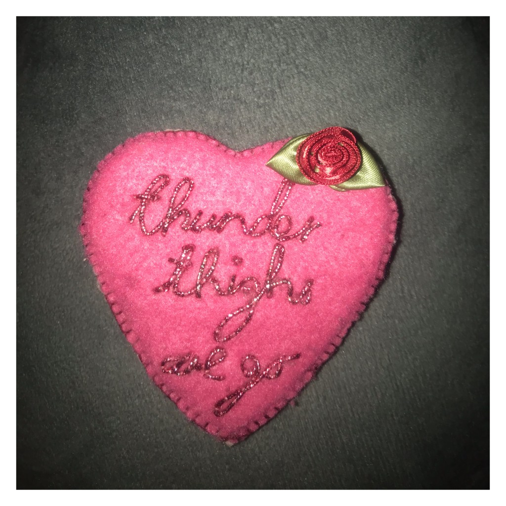 Pink felt brooch with ‘thunder thighs are go’ embroidered 