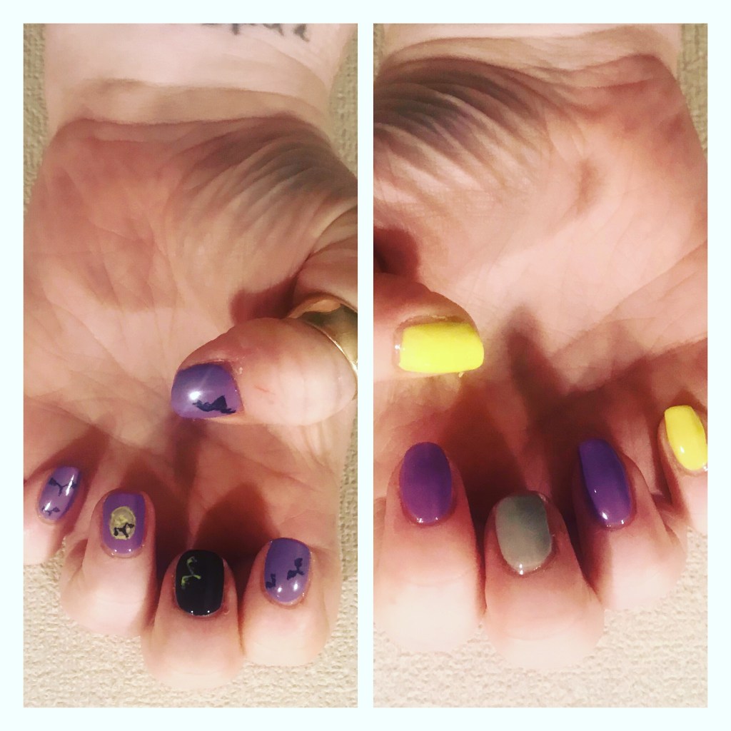 Halloween manicure with bat silohoutres against purple skies 