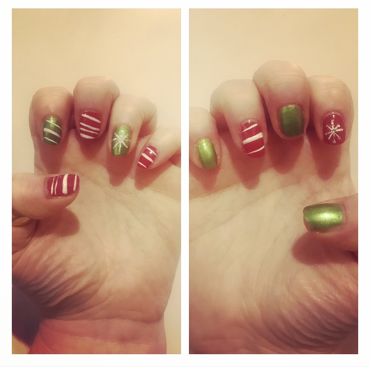 Red and green candy stripe nails with white snow flake accent