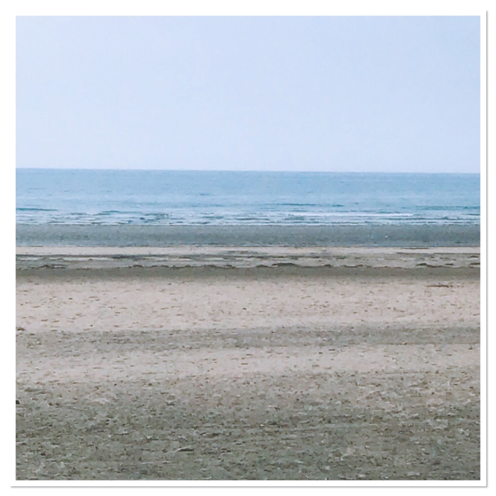 Calm blue sea & sandy beach 