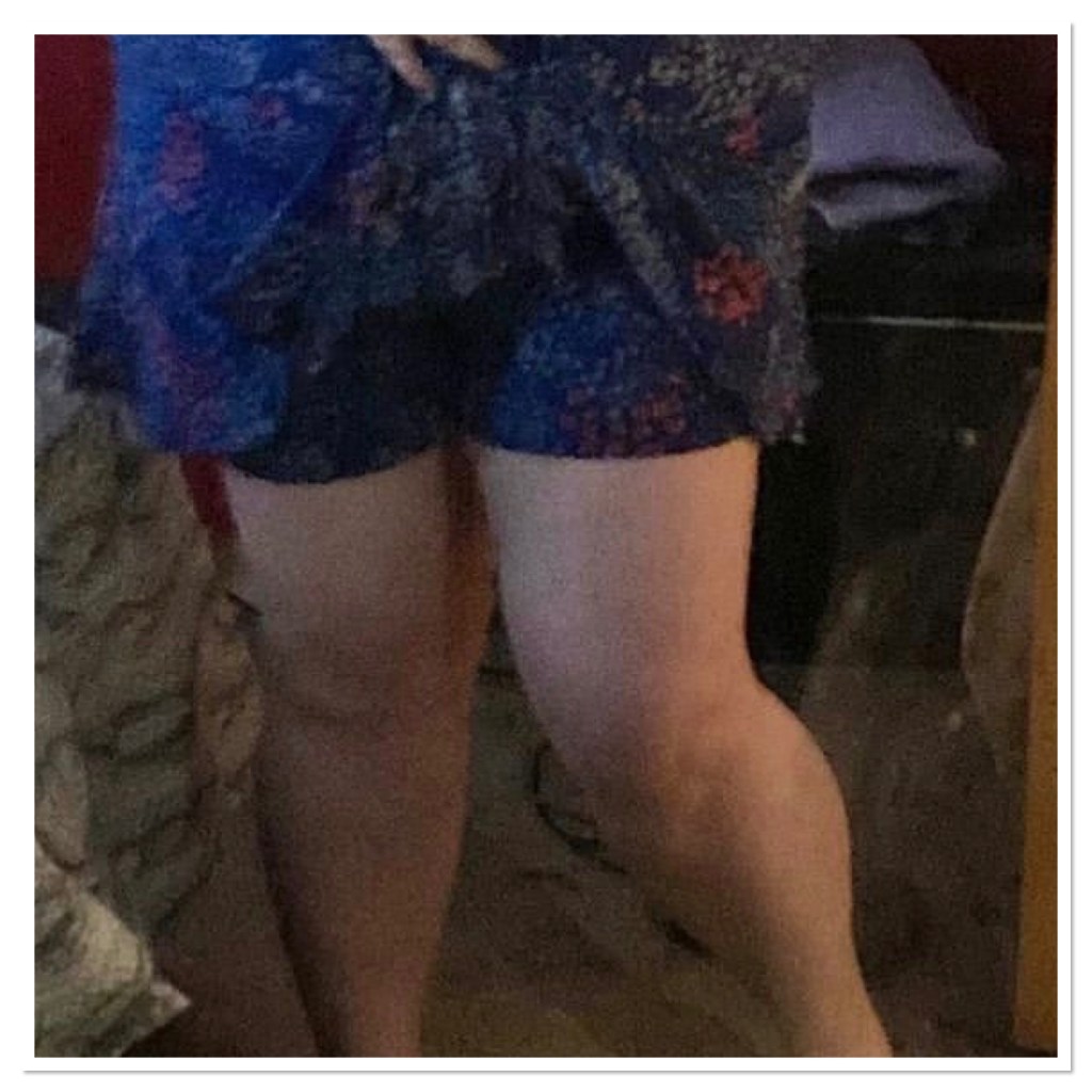 Ly is lifting floral skirt to shoe shorts attached beneath 