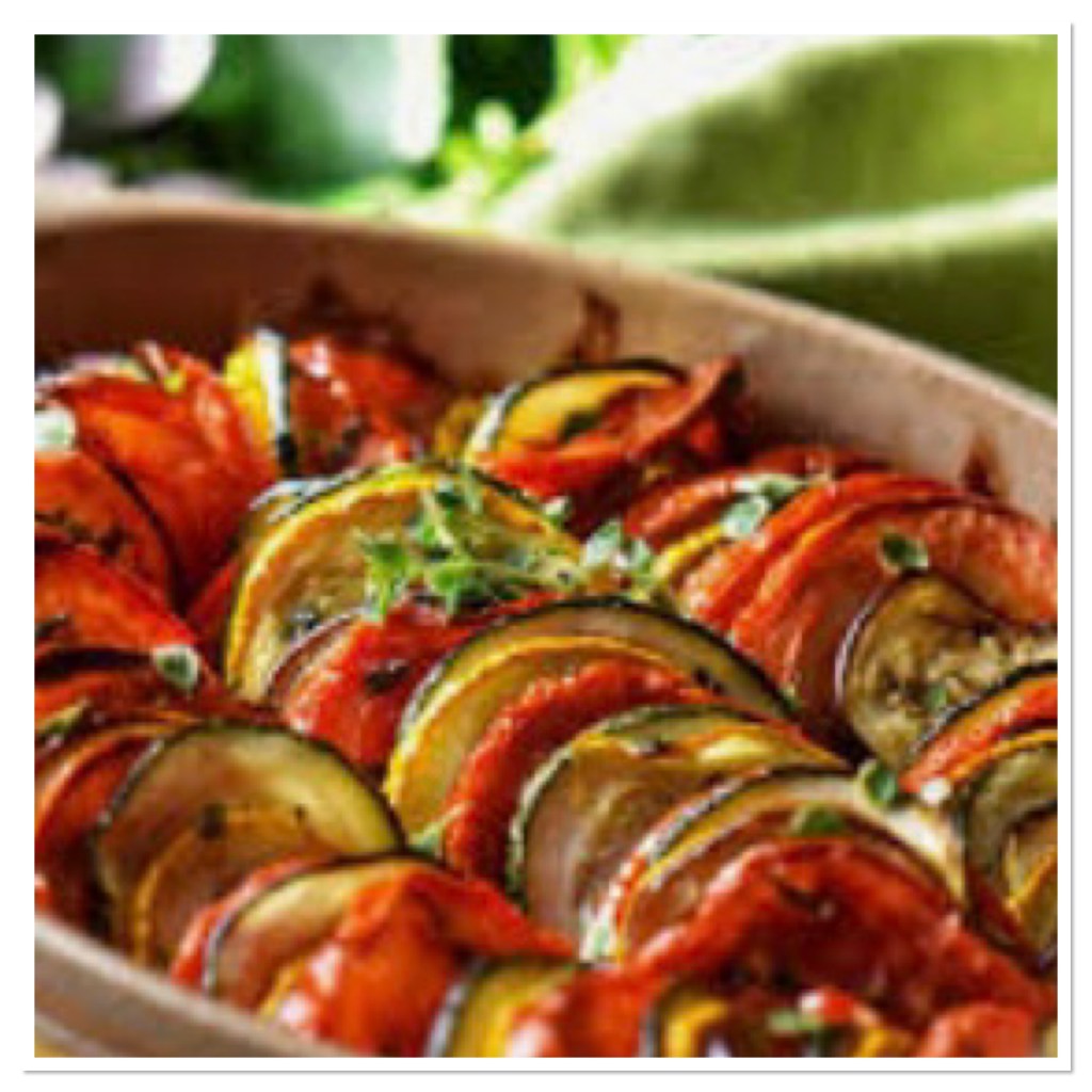 Thinly sliced roasted Mediterranean veg in casserole dish 