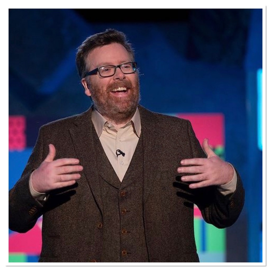 Bearded, smiling man in thee piece tweed suit